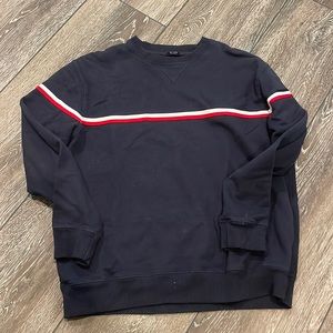 Navy blue crewneck sweatshirt with a blue, white and red stripe